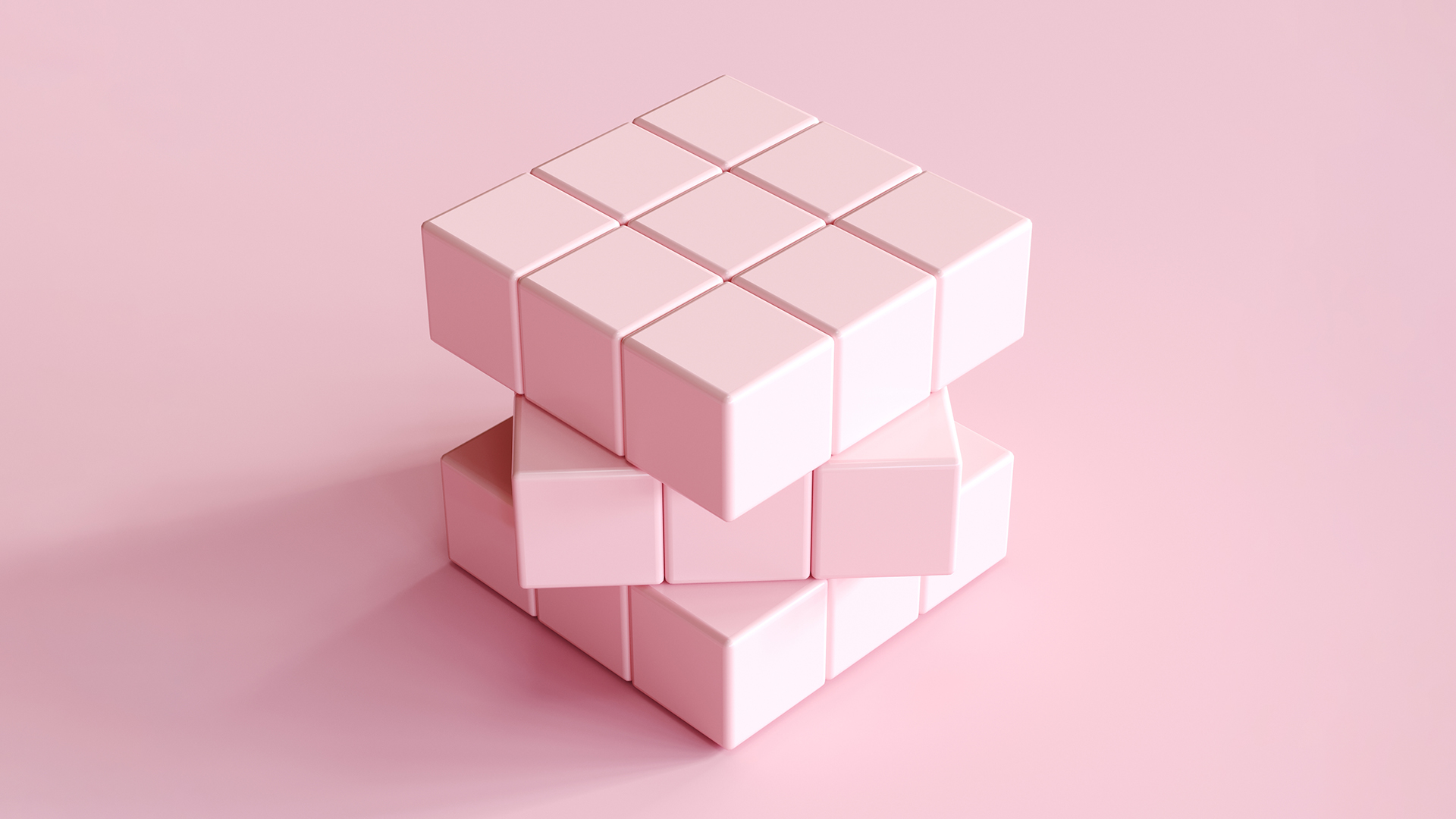 Light pink Rubik's cube on light pink background. 