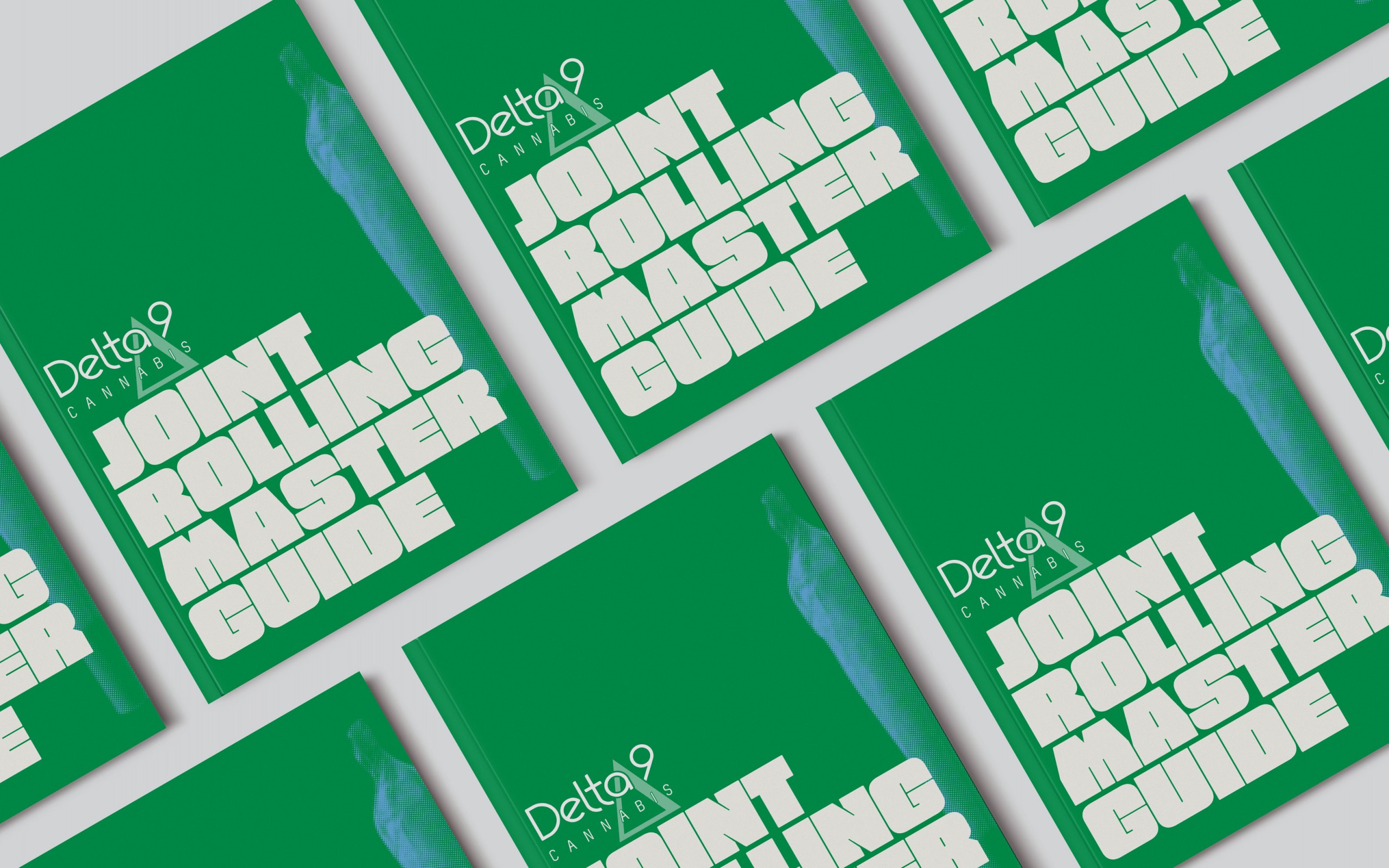 Several Delta9 Joint Rolling handbooks spread evenly across a white background.