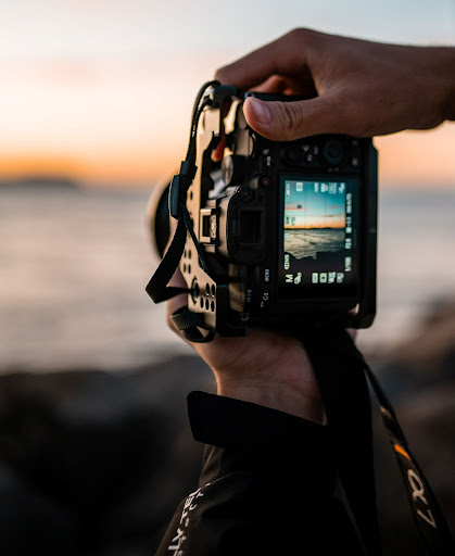 Camera viewfinder in the foreground with oceanscape in the background.