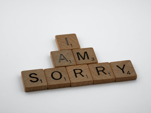 Scrabble tiles spelling "I am sorry."
