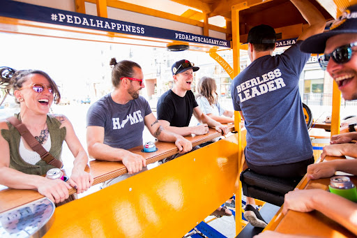 Individuals enjoying a ride on the Pedal Pub.
