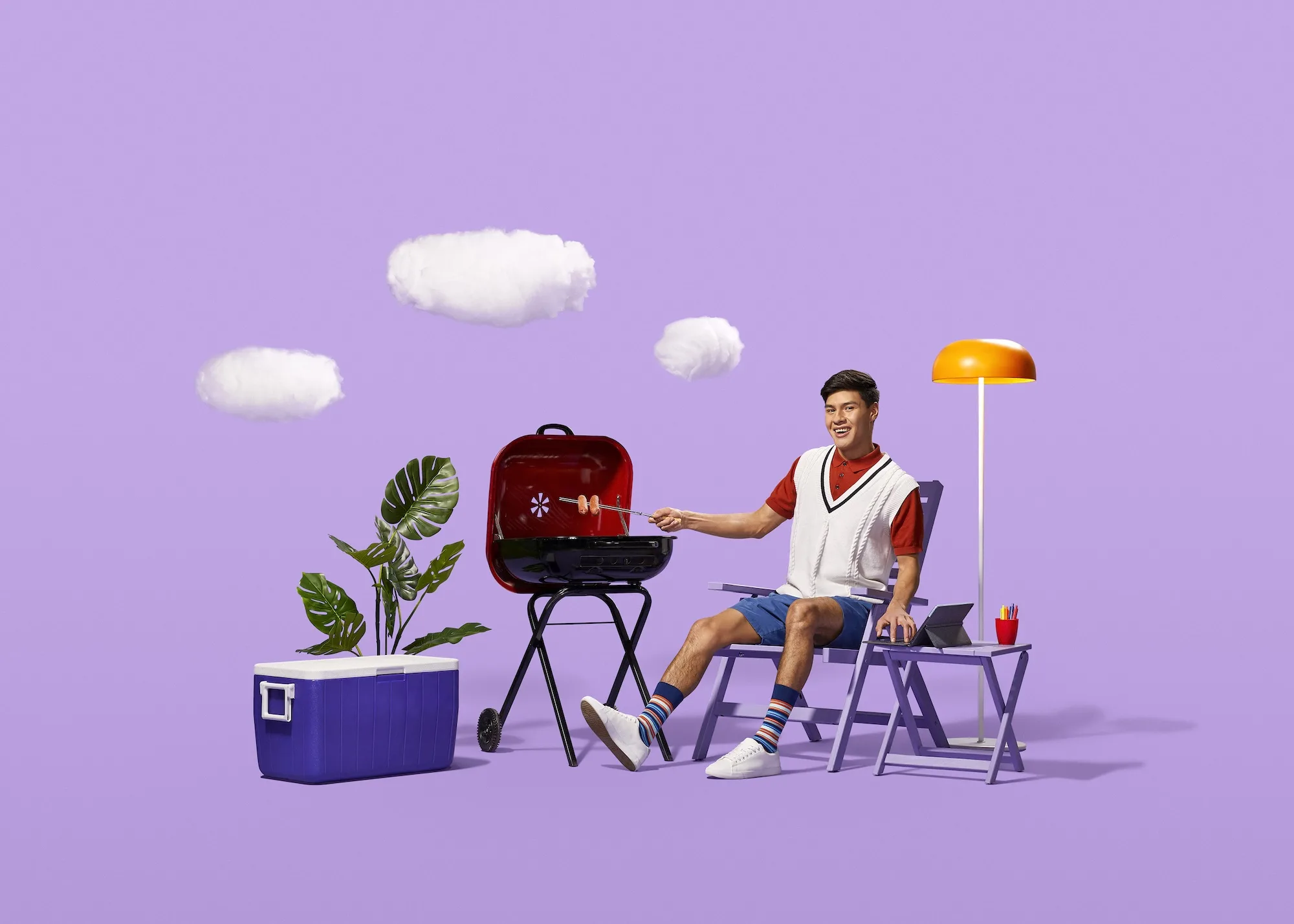 09-TECHNATION-CR-summer_EDIT_72DPI TECHNATION student BBQ'ing with beach accessories on a purple background.