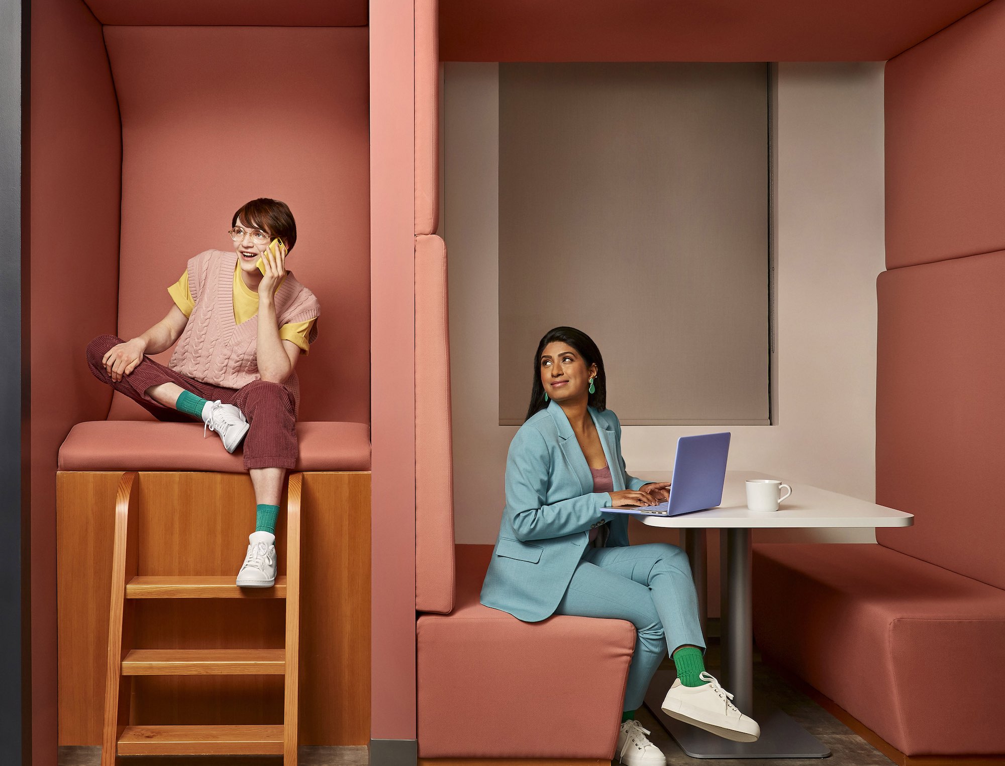 A student and employer at work in a stylized upholstered office space office space
