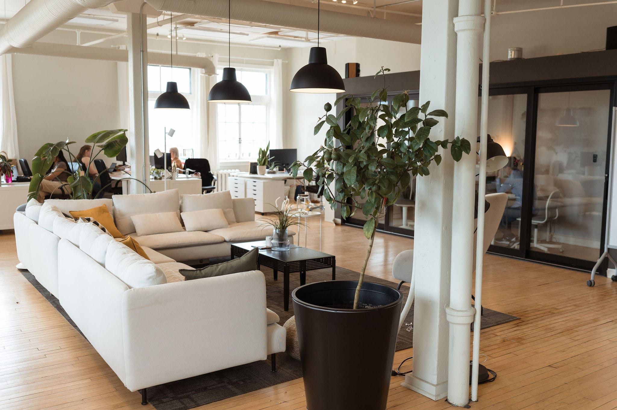 The UpHouse office, featuring an open concept and large white L-shaped couch
