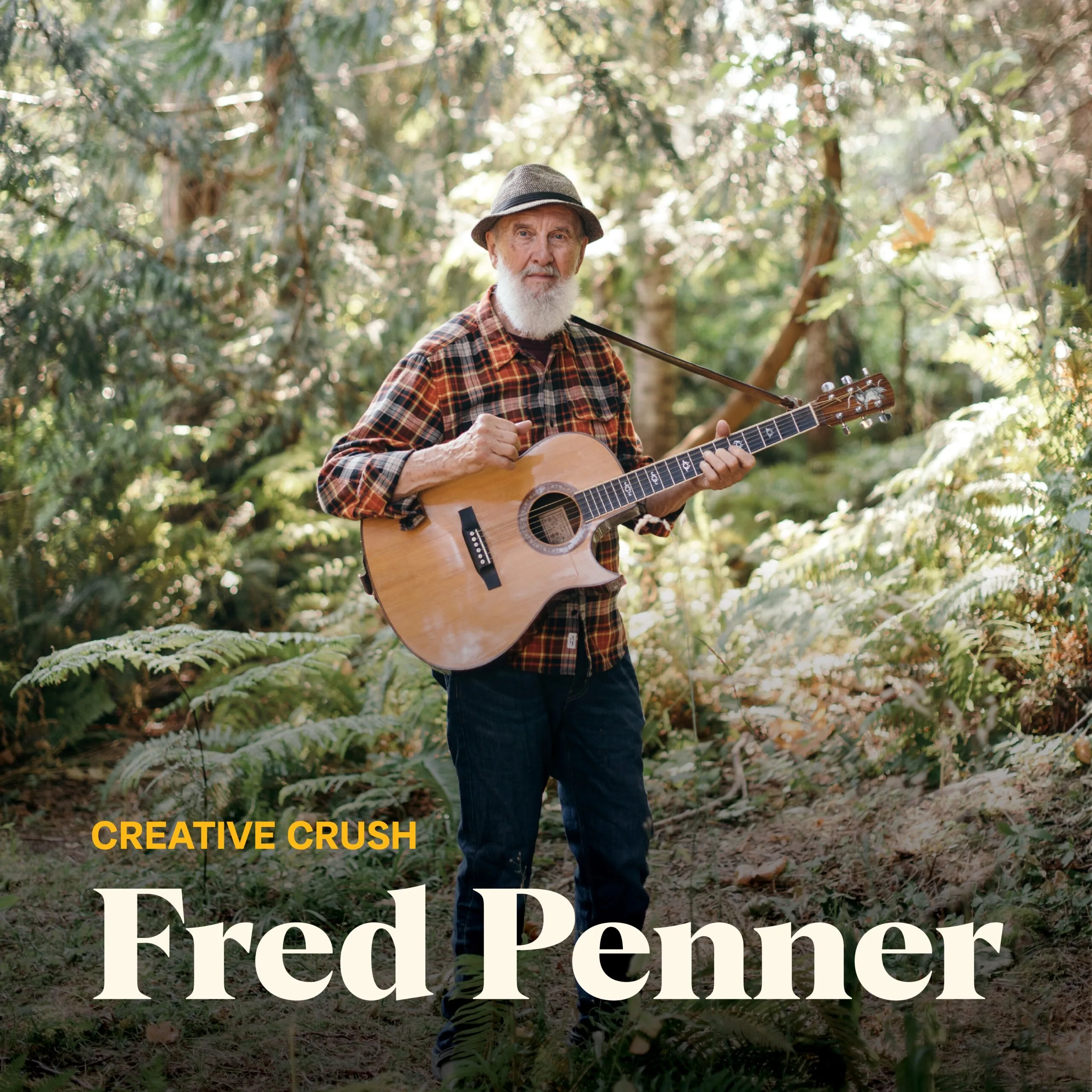 Fred Penner standing in the woods with his guitar