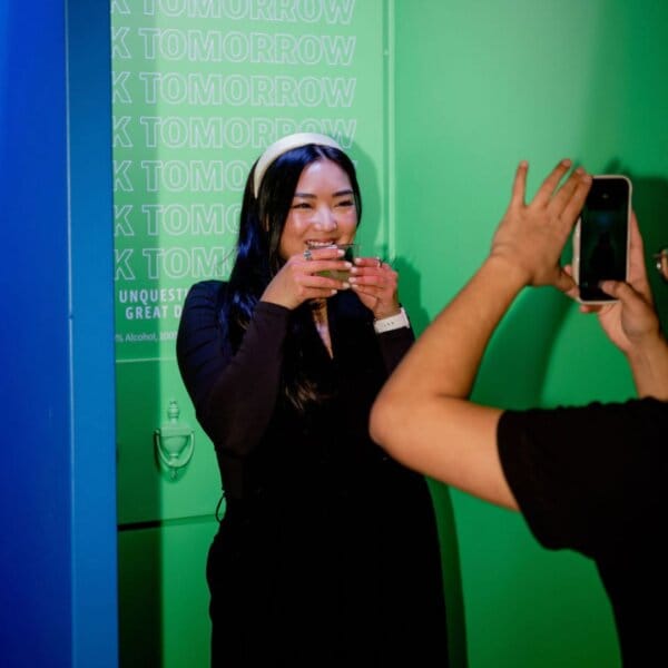 Person being photographed with a mocktail at a DrinkSense event