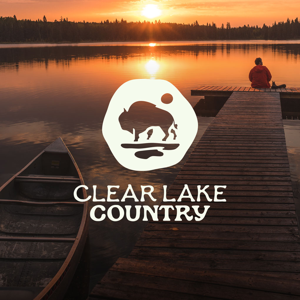 Clear Lake Country Logo with a photo of a person sitting on a doc at Clear Lake in the background.