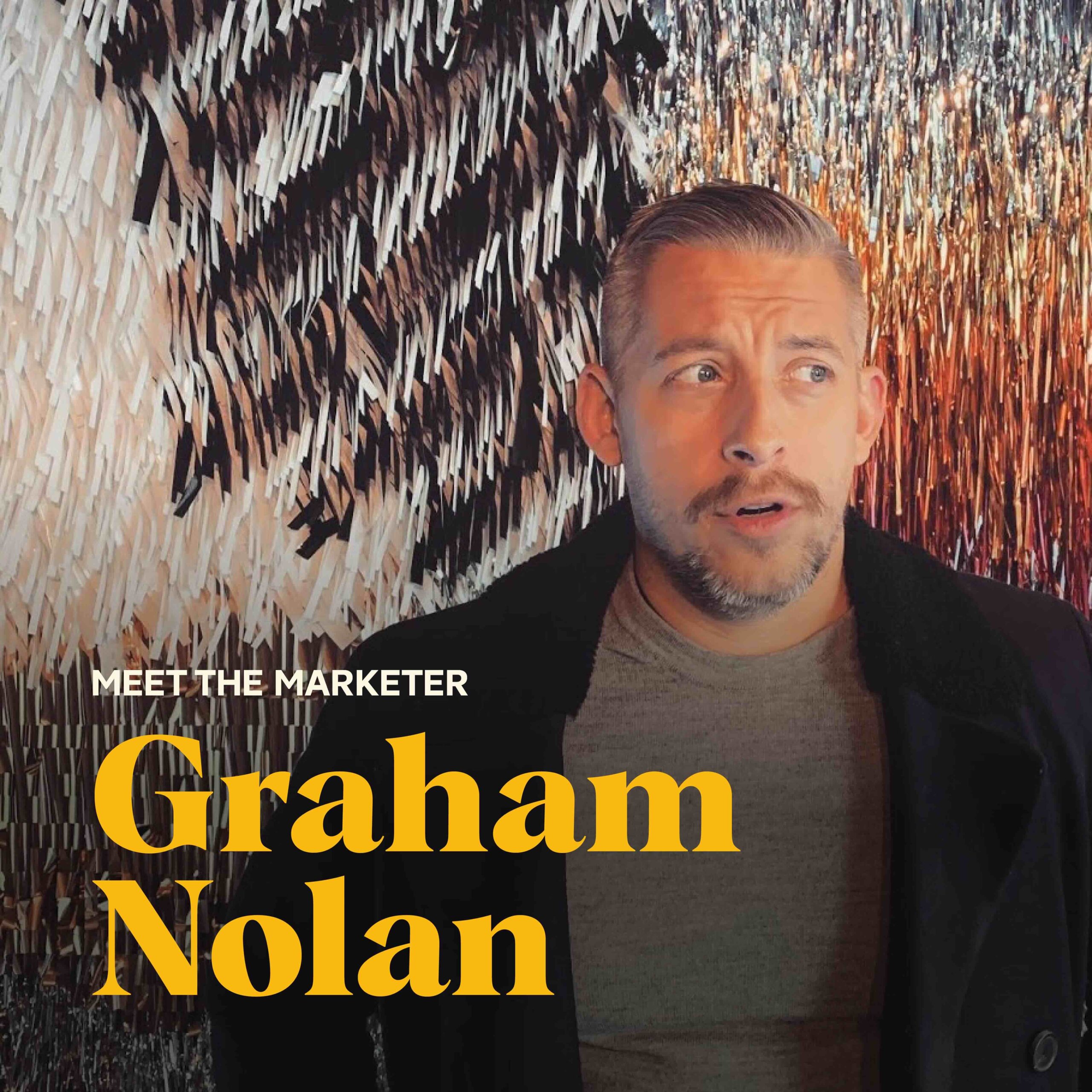 Graham Nolan standing with a sparkling background behind him.