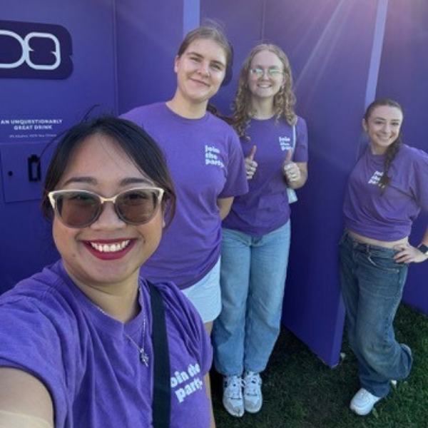 4 Four people at the DrinkSense activation wearing purple shirts.